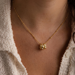 Load image into Gallery viewer, Close-up of a person wearing a gold necklace with a pendant.