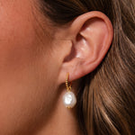 Load image into Gallery viewer, Close-up of an ear wearing a pearl earring with gold hoop.