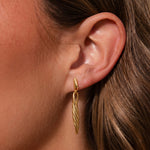 Load image into Gallery viewer, Gold earring worn by a person with brown hair.
