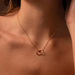 Load image into Gallery viewer, Interlocking to Ring circle pendant necklace in a rose gold on a woman neck