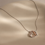 Load image into Gallery viewer, Necklace with a heart-shaped pendant on a beige surface