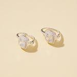 Load image into Gallery viewer, Two silver earrings with large gemstones on a beige background