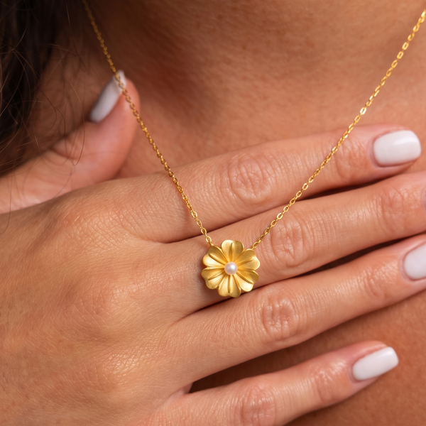 18k Gold plated necklace with a floral pendant worn by a person