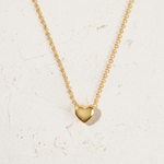 Load image into Gallery viewer, Gold heart-shaped pendant necklace on a light background
