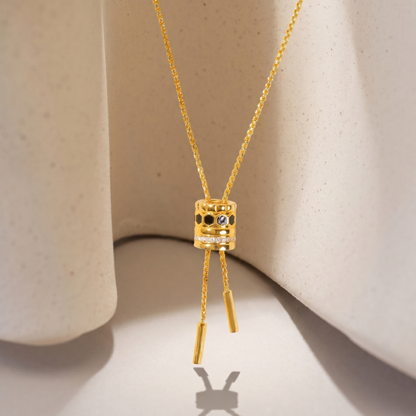 Gold necklace with a pendant on a beige background