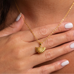 Load image into Gallery viewer, Gold plated necklace with a shell pendant worn by a person
