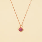 Load image into Gallery viewer, Necklace with a pink pendant on a beige background
