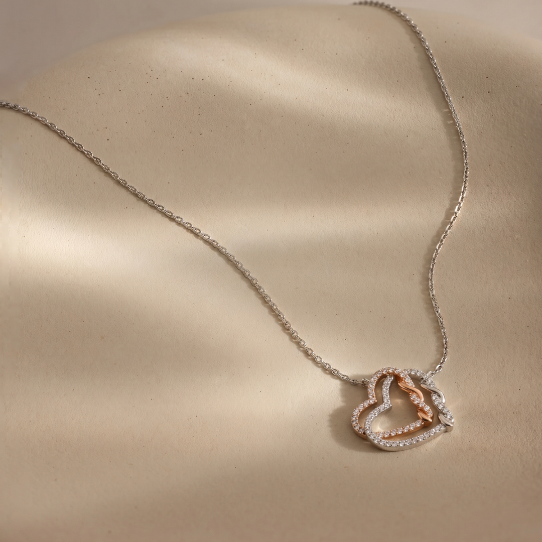 Necklace with a heart-shaped pendant on a beige surface