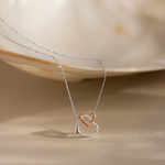Load image into Gallery viewer, Necklace with a heart-shaped pendant on a beige background
