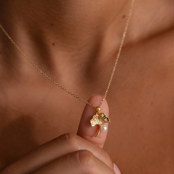 ginko leaf shape gold plated necklace on woman's neck