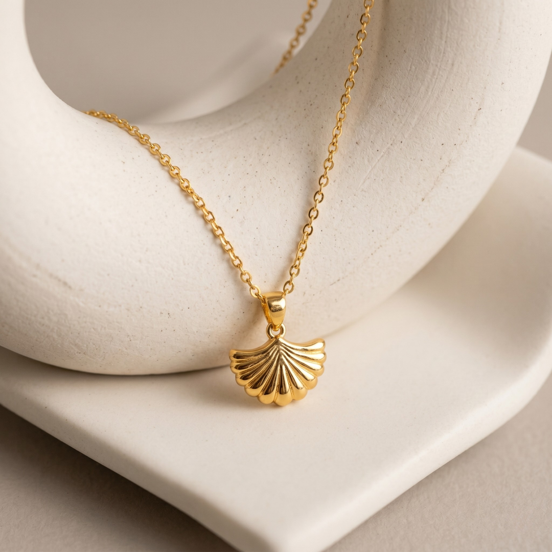 leaf shell shape gold plated necklace on white prop