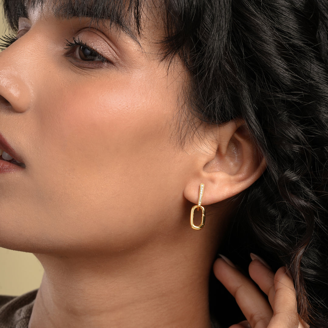 Close-up of a woman wearing a gold hoop earring.
